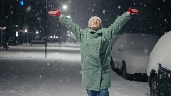 Cinematic Shot of Carefree Happy Smiling Young Woman Wearing Warm Hat is Excited and Amazed with