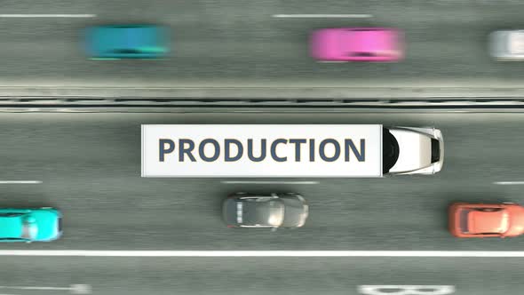 Trucks with PRODUCTION Text Driving Along the Road