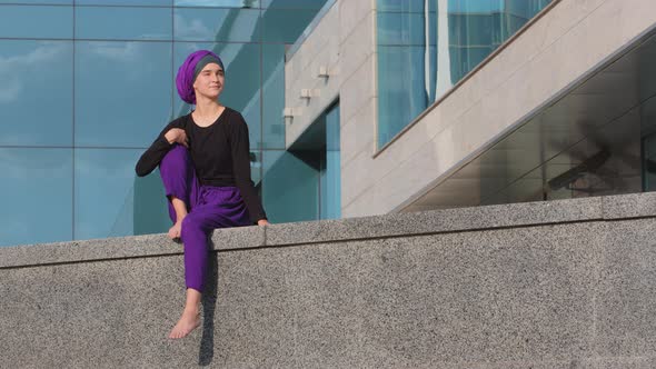 Calm Young Muslim Girl Buddist in Hijab Lonely Lady Female Beautiful Woman Sits on Building City