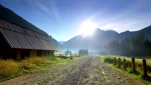 Rocky road between cottages in the valley Chocholowska at sunrise, Tatra Mountains, Poland
