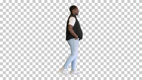 Attractive black man walking with hand in his pocket, Alpha Channel