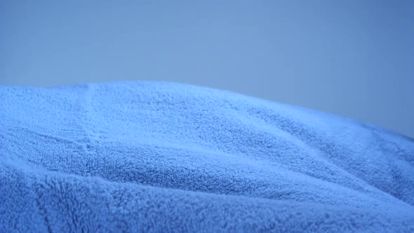 Rolling blue towel in midair, Slow Motion