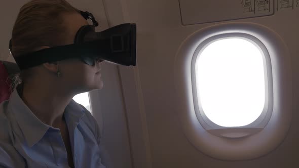 Woman exploring virtual world during the flight