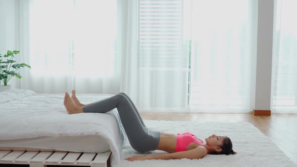 Asian woman in sportswear workout excercise at home