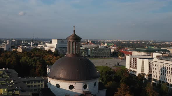 Fly Around Large Brown Dome Roof of Holy Trinity Church at Pilsudski Square in City Centre