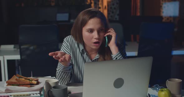 Dissapointed Female Office Worker Talking on Phone with Her Boss , Telling Her To Finish Lot of Work