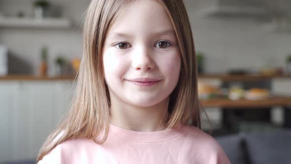 Cute Adorable Small Kid Girl Looking at Camera at Home Close Up Face Portrait