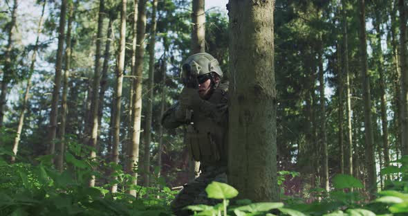 Portrait of Soldier in Uniform in Dense Forest Ready for Military Action