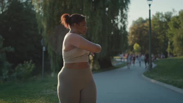 Woman exercising at the park in summer day. Shot with RED helium camera in 8K.