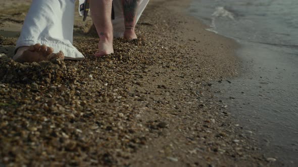 Closeup Man Legs Stretching on Wet Sand