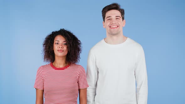 Cheerful African Woman and White Man Showing Yes Sign Nods Heads Approvingly