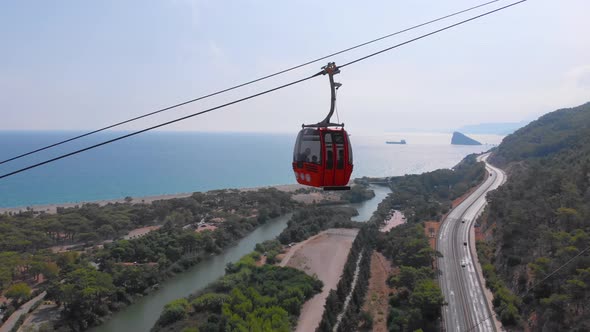 Close-up Flight Next To the Uphill Funicular with the Coast in the Background 