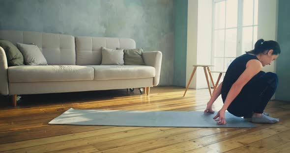 Woman in Sportswear Lies Down on Mat Do Sports Exercises