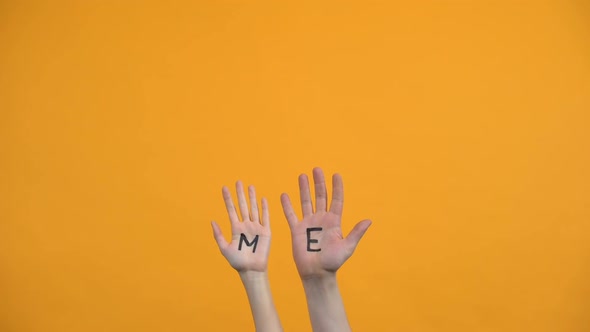 Me Written on Palms Orange Background, Male and Female Volunteers, Charity