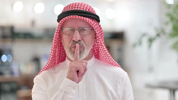 Senior Old Arab Businessman Putting Finger on Lips, Quiet 