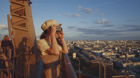 Young girl taking photo at sunset