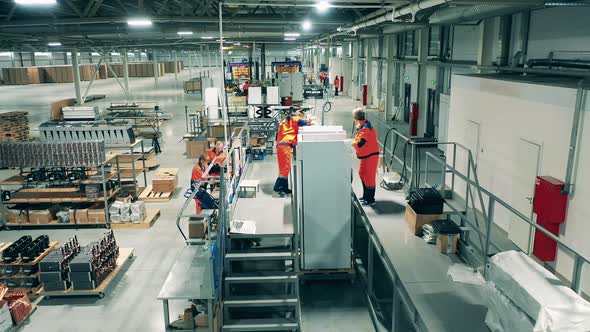 Manual Assembly of Fridges Carried Out By Factory Workers