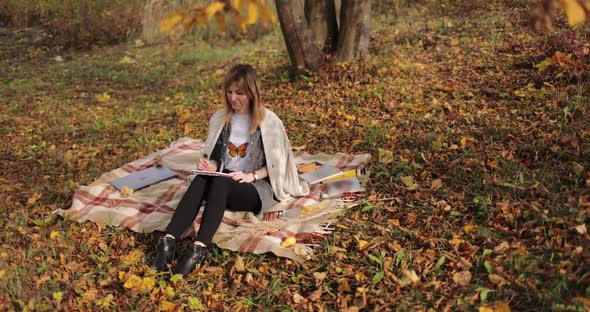 Woman Sketching in Autumn Park