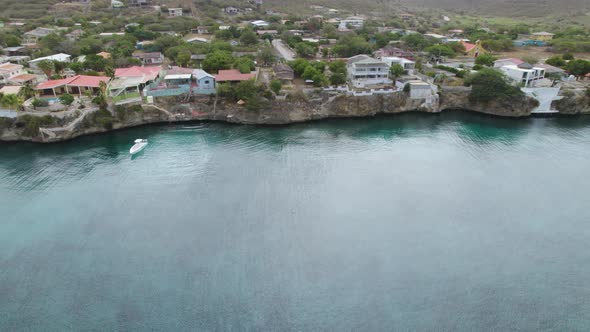 Aerial trucking shot of the Lagun in the Caribbean with clear emerald waters