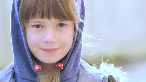 Portrait of Happy Child Girl in Warm Clothes in Autumn Outdoors