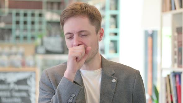 Portrait of Sick Young Man Coughing