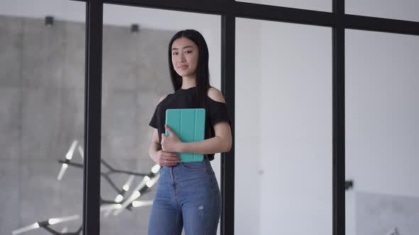 Portrait of Successful Gorgeous Asian Businesswoman Posing in Office Holding Tablet