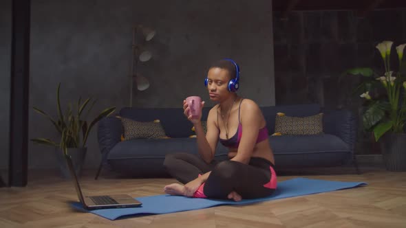 Sporty Woman in Headphones Enjoying Music Indoors