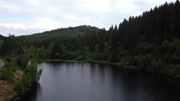 Mountain lake with turquoise water and green trees. Reflection in the water. Beautiful spring landsc