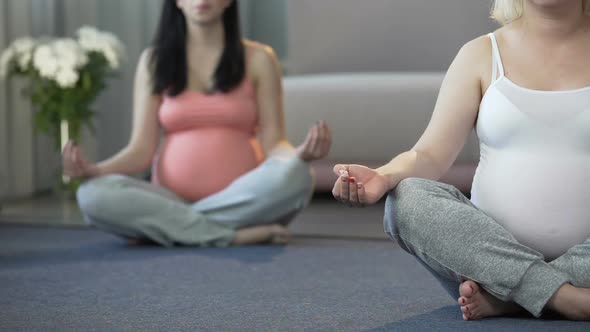 Two Women Doing Yoga Exercises for Pregnant to Relax and Calm Down at Home