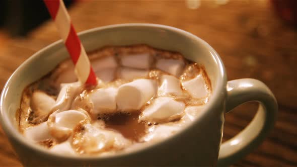 Cup of coffee with straw on a table