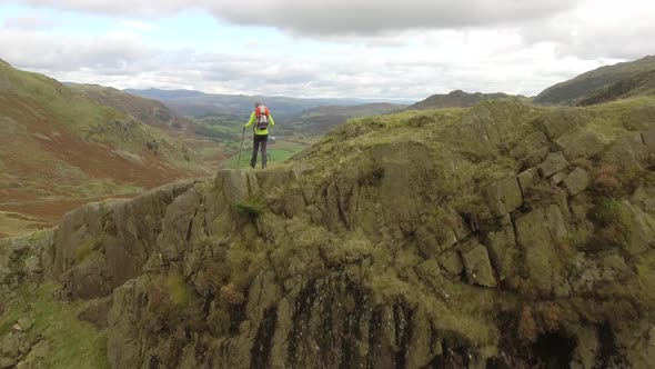 Hiker aerial view hiking in the hills