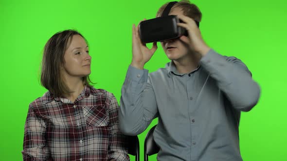 Man and Woman Using VR Headset Helmet To Play Game. Watching Virtual Reality 3D Video. Chroma Key