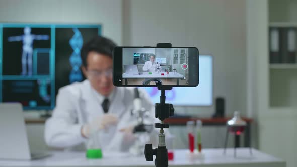 Asian Scientist Man Using Smartphone Recording Video While Researching In The Laboratory