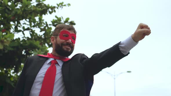 Senior Portrait Positive Smiling Bearded Businessman in Red Cloak and Superhero Glasses