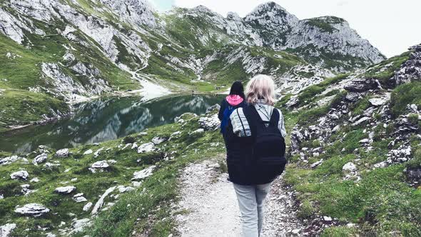 Back View of Family During a Mountain Trip Along Italian Alps