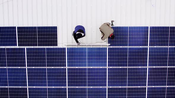 Solar Technician Installing Solar Panels on House Roof