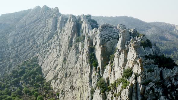 Aerial shot and fly into dangerous limestone rock