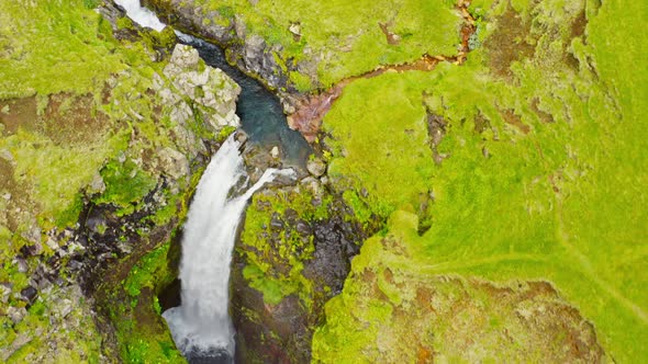 Lush Green Cascading Waterfall Gluggafoss In Iceland. Aerial Drone Panning Up.