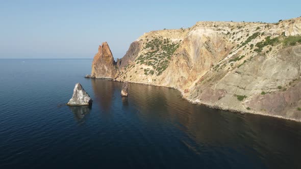 Aerial View From Above on Calm Azure Sea and Volcanic Rocky Shores