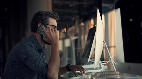 Businessman Working Alone. Man Chatting In Office Computer At Night. Graphic Designer Overworked.