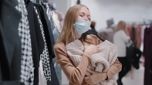 Happy Client Buyer Female Customer Girl in Medical Mask Happily Dancing in Cloth Store Shopping Mall