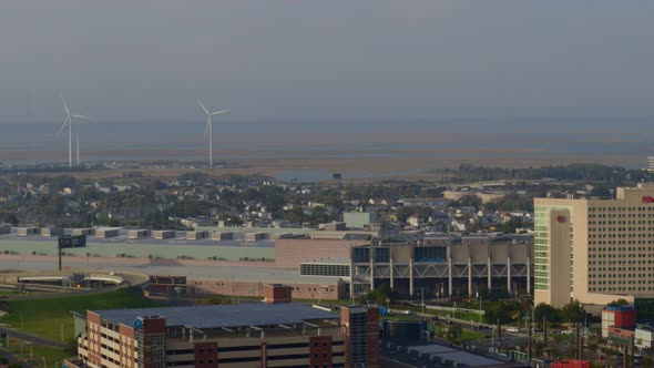 Aerial of flyover, city settlement and windmills in Atlantic city