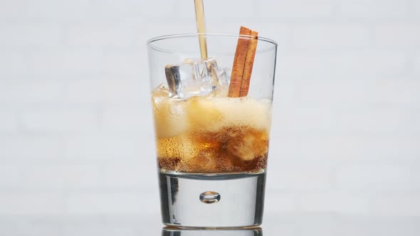 Non-alcoholic refreshing cocktail made of cola, ice, cinnamon