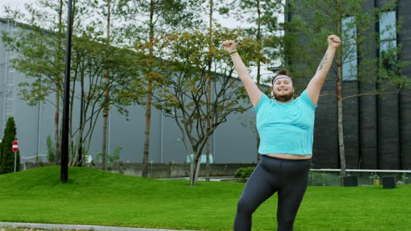 Obese Young Man Dancing Funny in Front of the