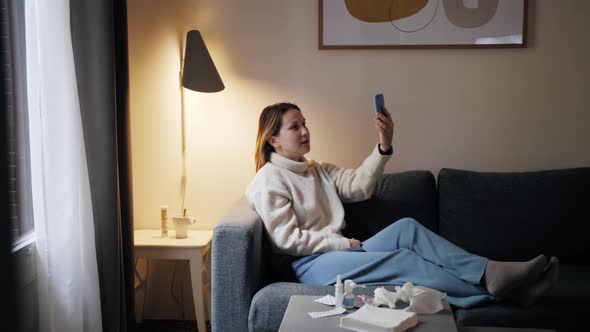 Female Patient at Apartment Talk to Doctor on Mobile Phone Video Call Conference Medical App in