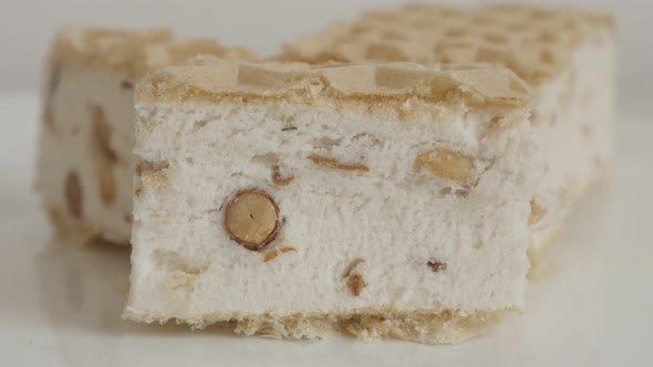 Piece of white halva in wafer sheets 4K footage