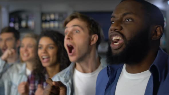 Cheering Group of Sport Fans Rejoicing Team Victory, Watching Match Together