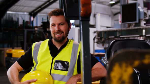 Engineer smiling in bottle factory