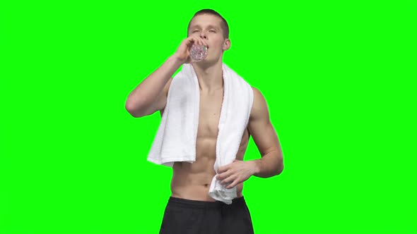 Sportsman Is Drinking Water and Towels. Green Screen