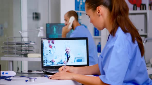 Resident Physician Talking to Doctor on Video Call During Virtual Meeting